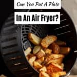 Air fryer basket with potato wedges.