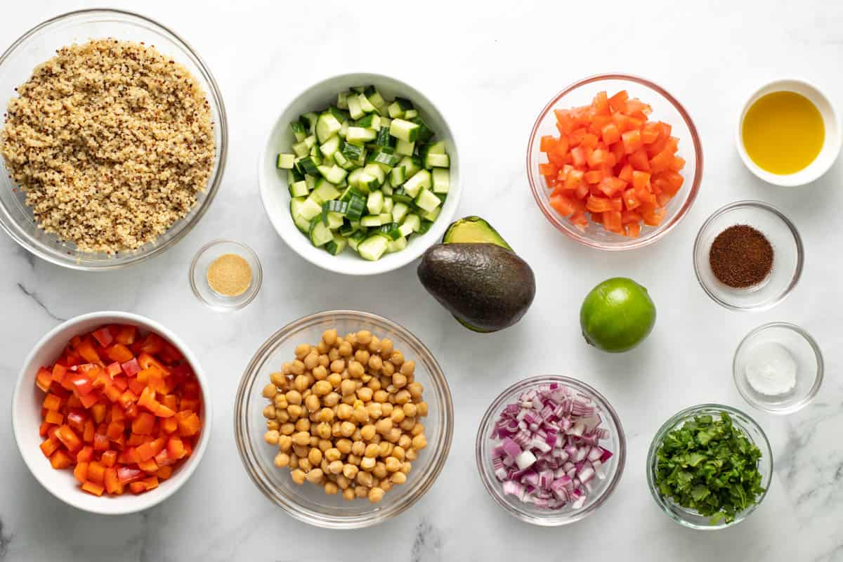 Chickpea Quinoa Salad Ingredients: quinoa, chopped cucumber, chopped tomato, chickpeas, red onion, chopped hers, spices, avocado, and lime. 