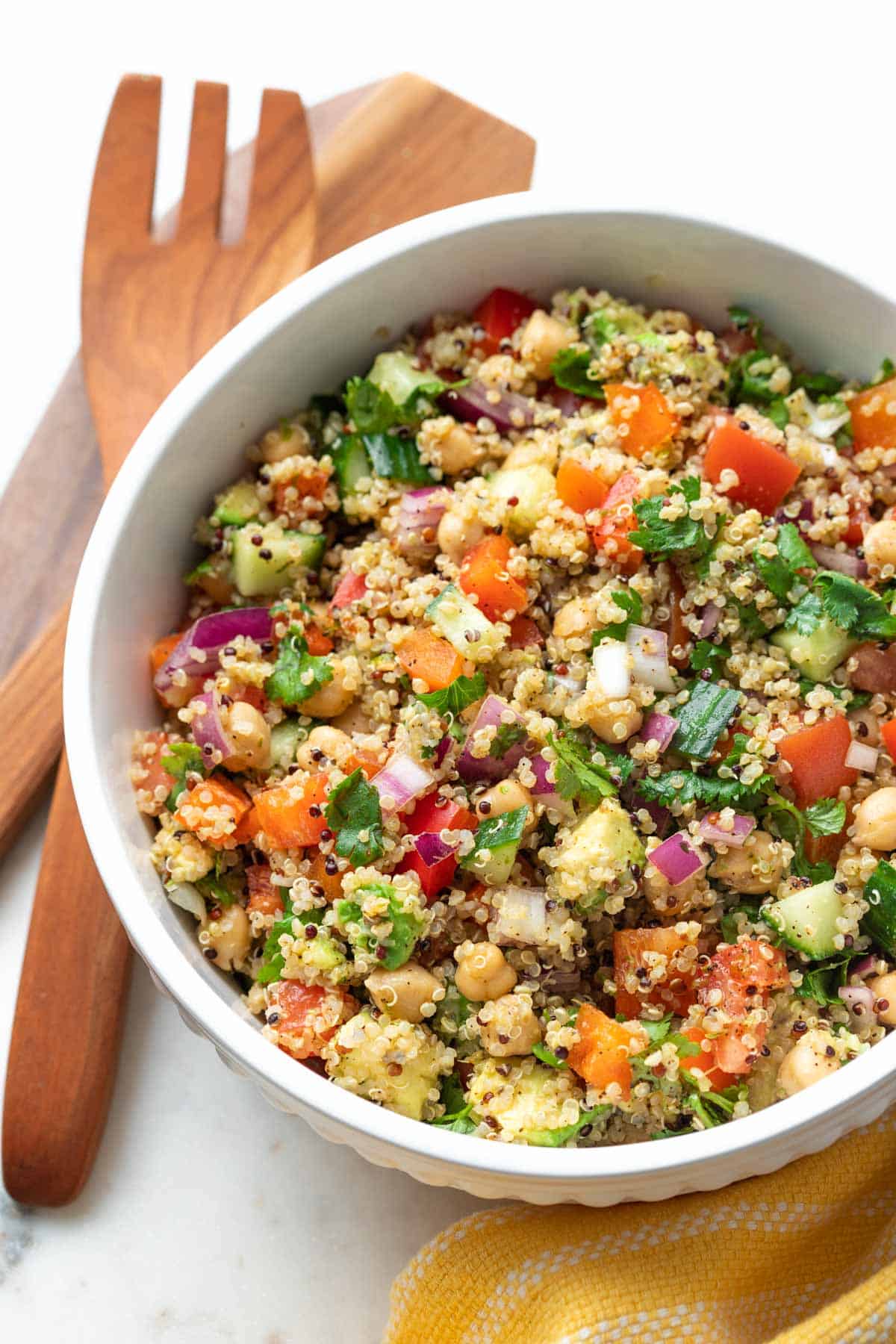 Bowl of chickpea quinoa salad with assorted vegetables. 