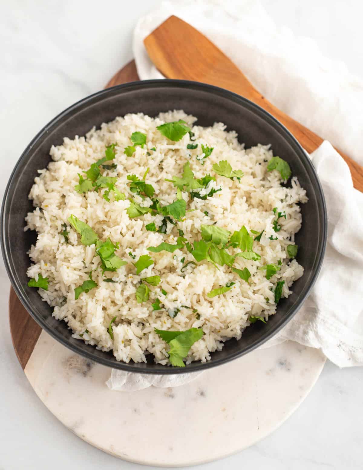 Cilantro lime rice in black serving bowl.
