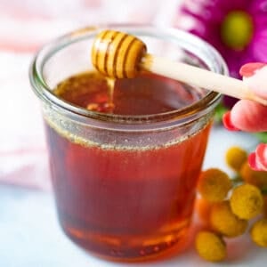 Honey wand dipped in vegan honey jar.