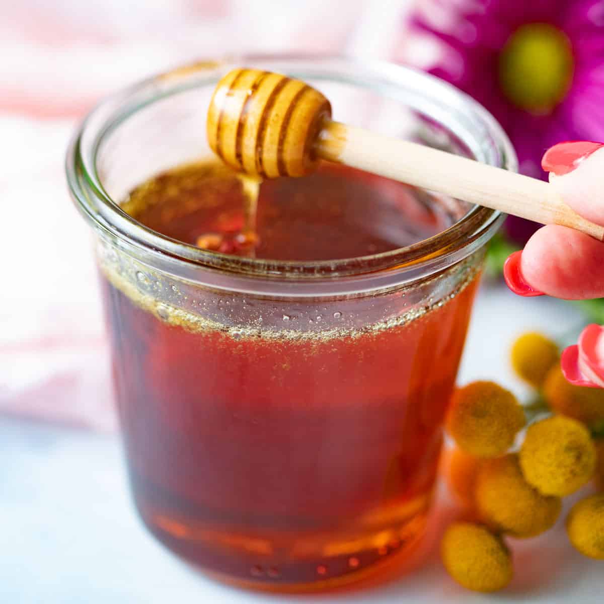 Honey wand dipped in vegan honey jar. 
