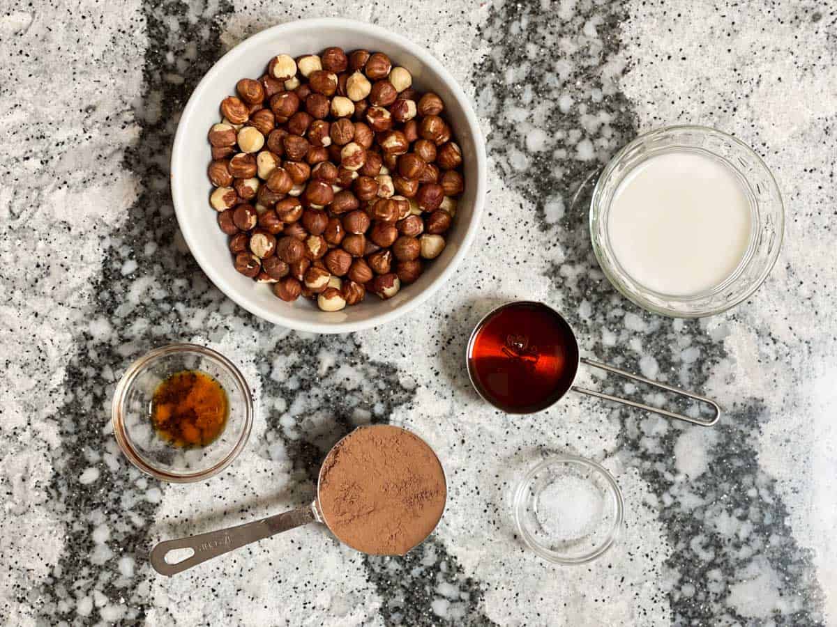 Vegan Nutella Ingredients: hazelnuts, almond milk, maple syrup, salt, cocoa powder, vanilla extract.
