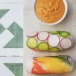 Rainbow summer rolls with dipping sauce.