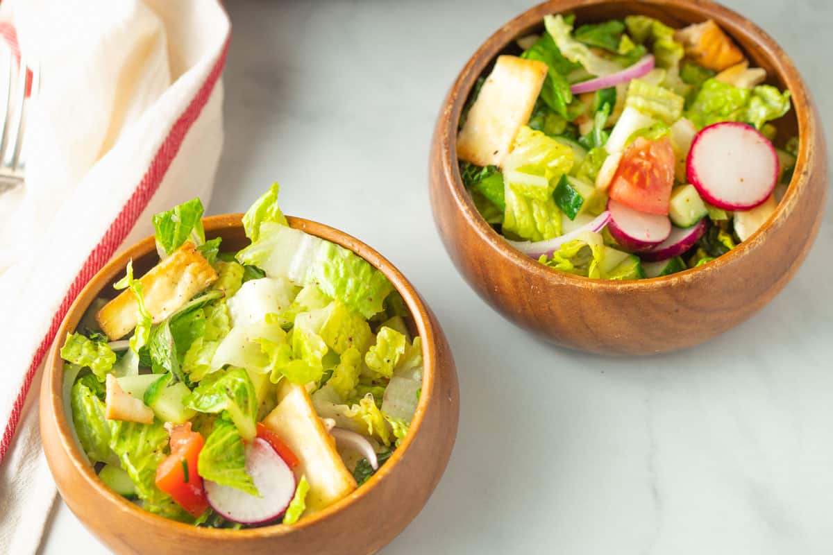 Fattoush salad in small wood bowls. 
