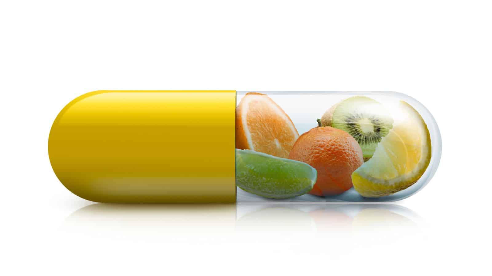 Vitamin capsule with citrus fruits inside.
