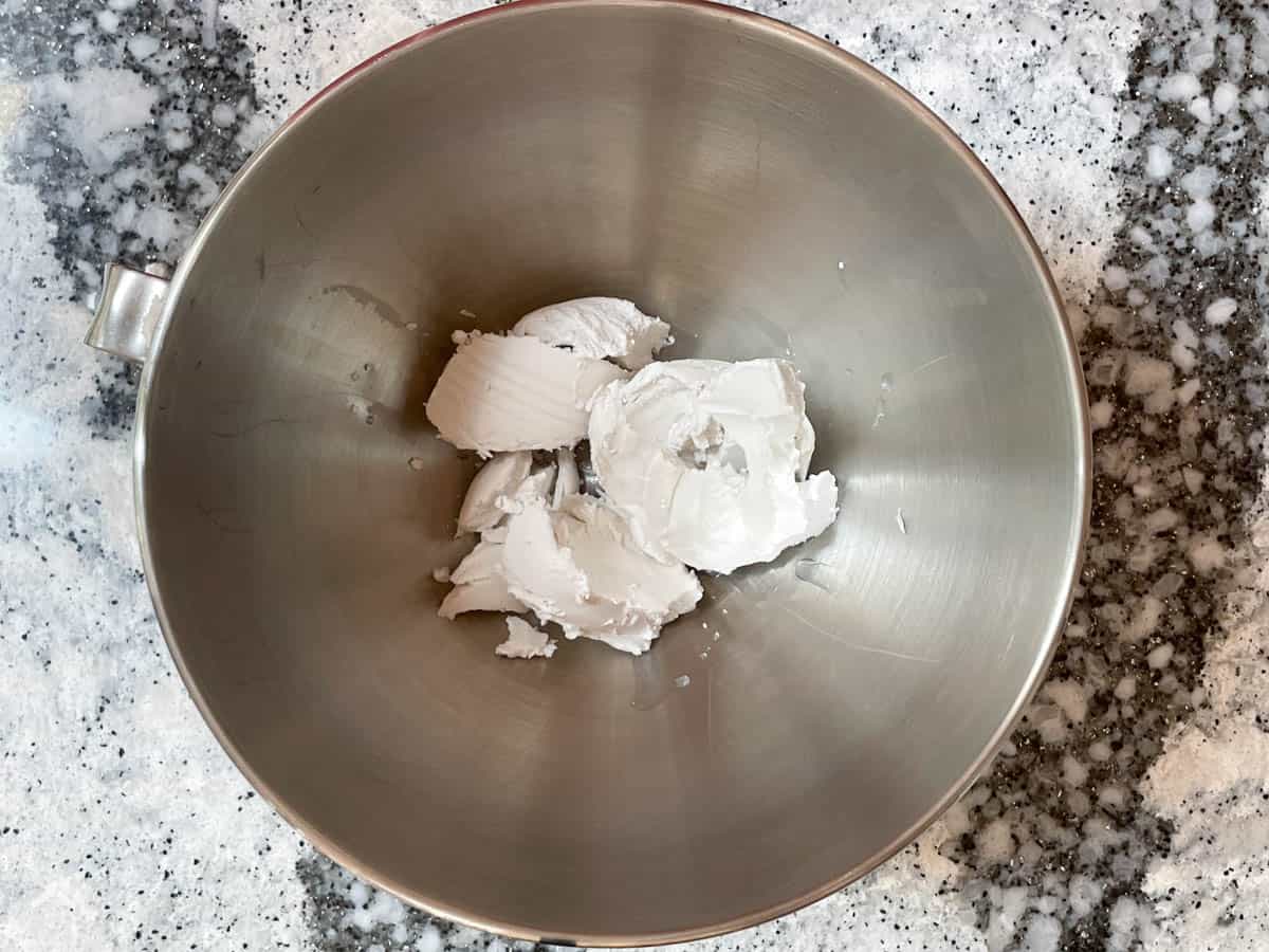 Hardened coconut cream in metal bowl.

