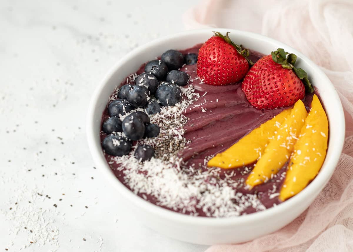 Acai bowl topped with fresh fruit.
