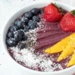 Acai bowl topped with fresh fruit.