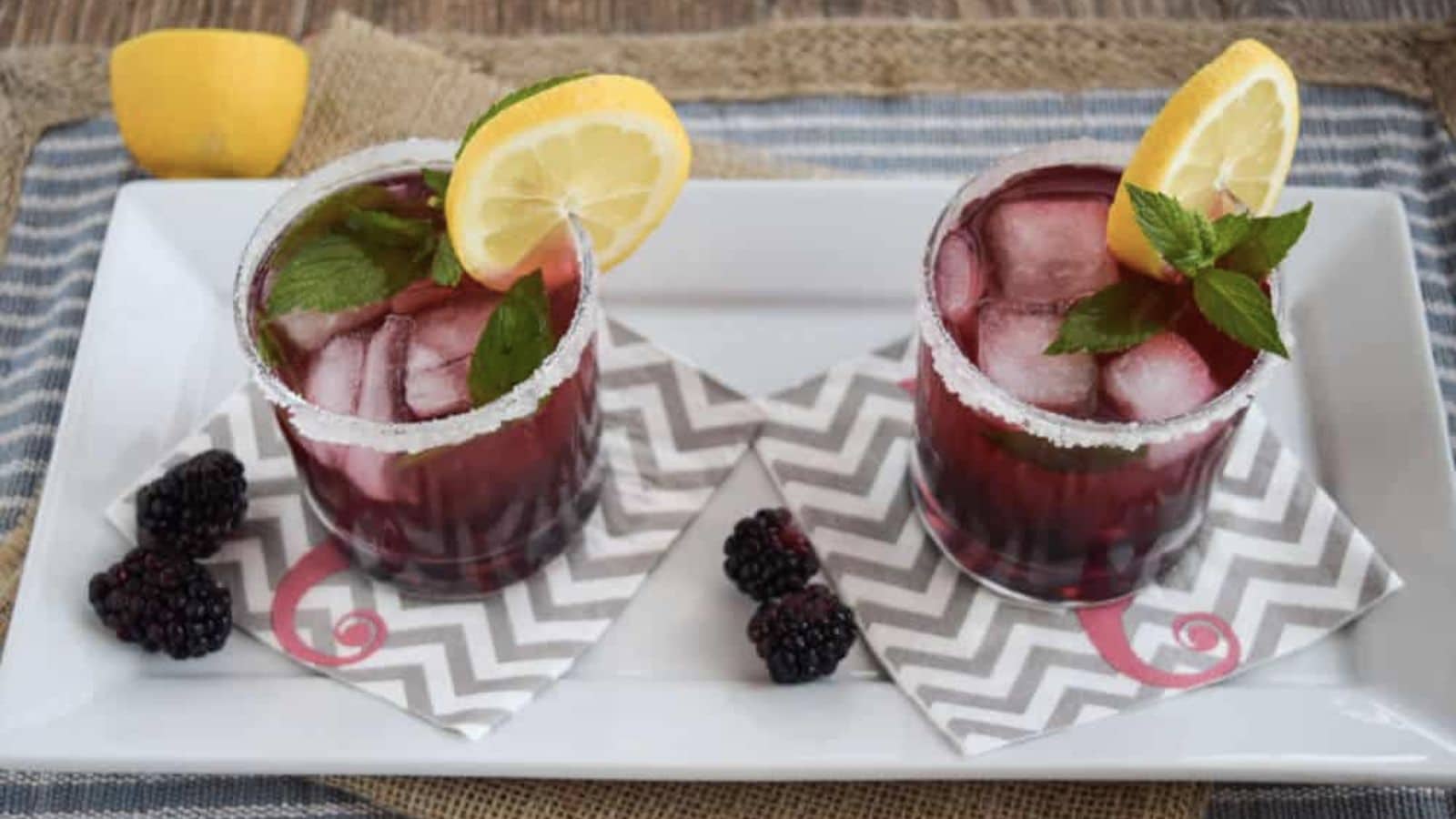 Blackberry vodka cocktails on a serving platter.