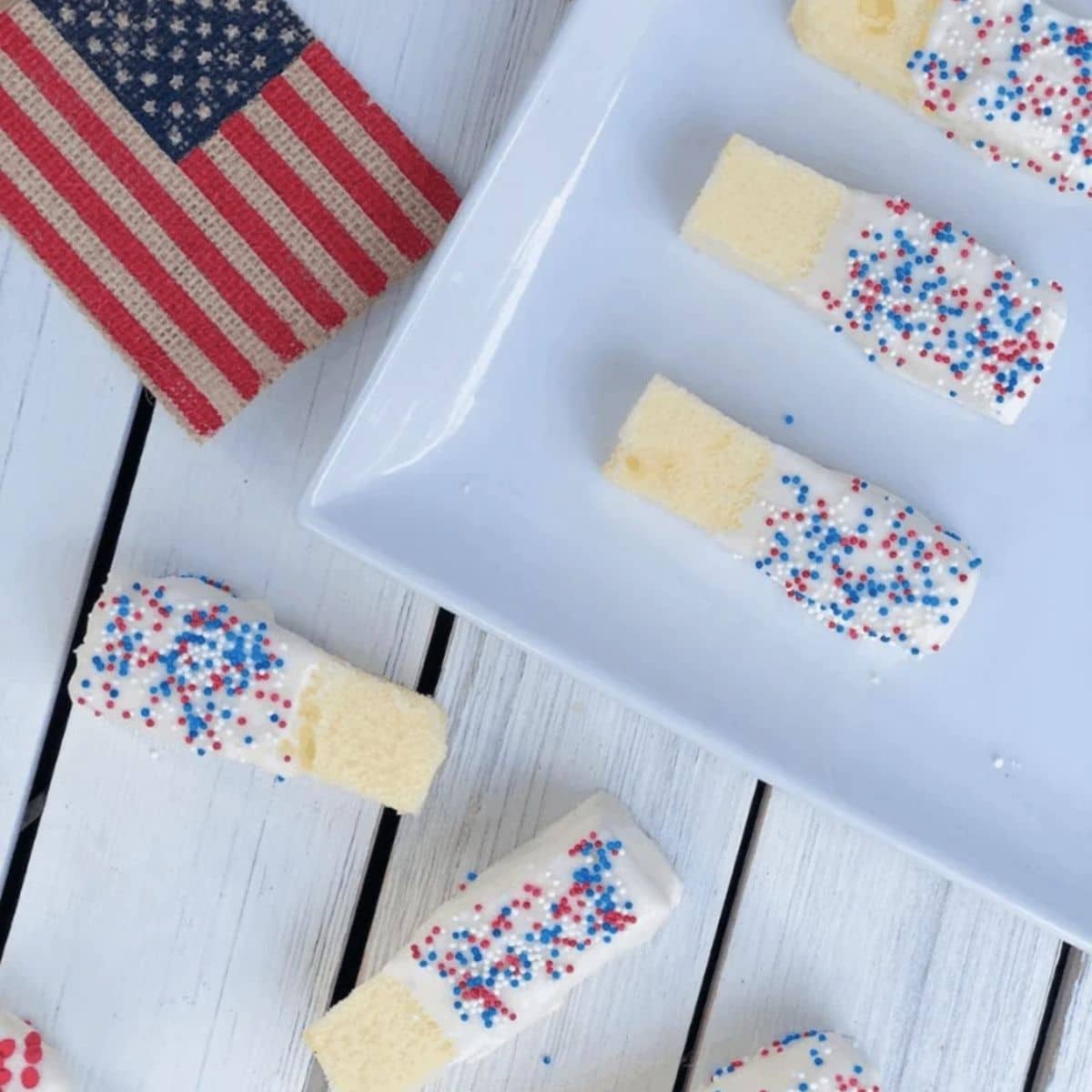 Pound cake slices dipped in white chocolate, and covered in red, white, and blue sprinkles.

