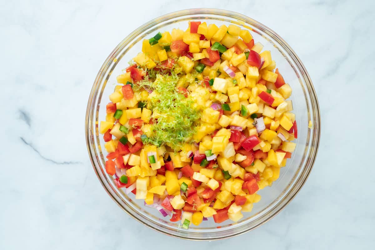 Pineapple mango salsa topped with lime zest and lime juice.