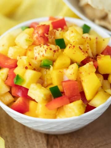 Pineapple mango salsa in a small white serving dish.