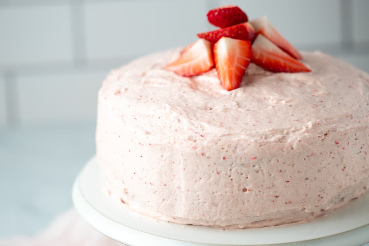 Strawberry cake on a cake stand.