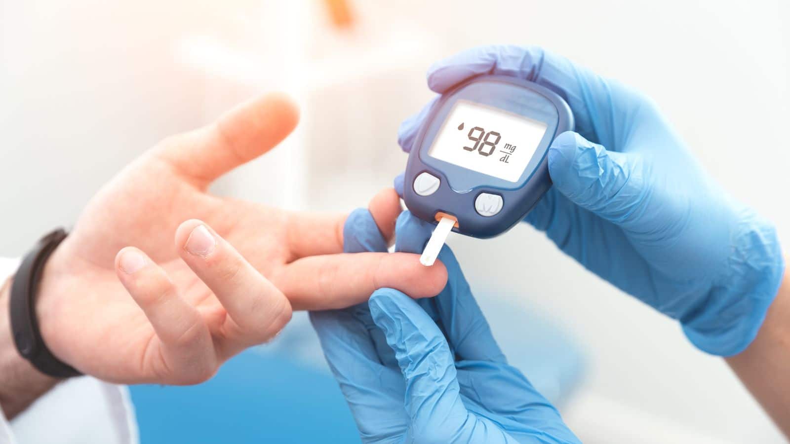 Man taking blood sugar with a glucometer.

