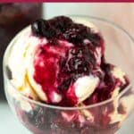 Berry compote on top of bowl of vanilla ice cream.