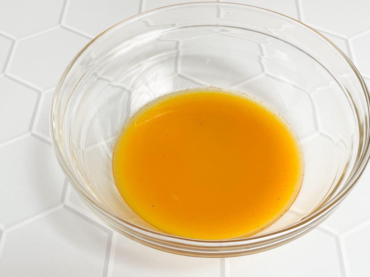 Lemon juice and turmeric whisked together in a bowl.
