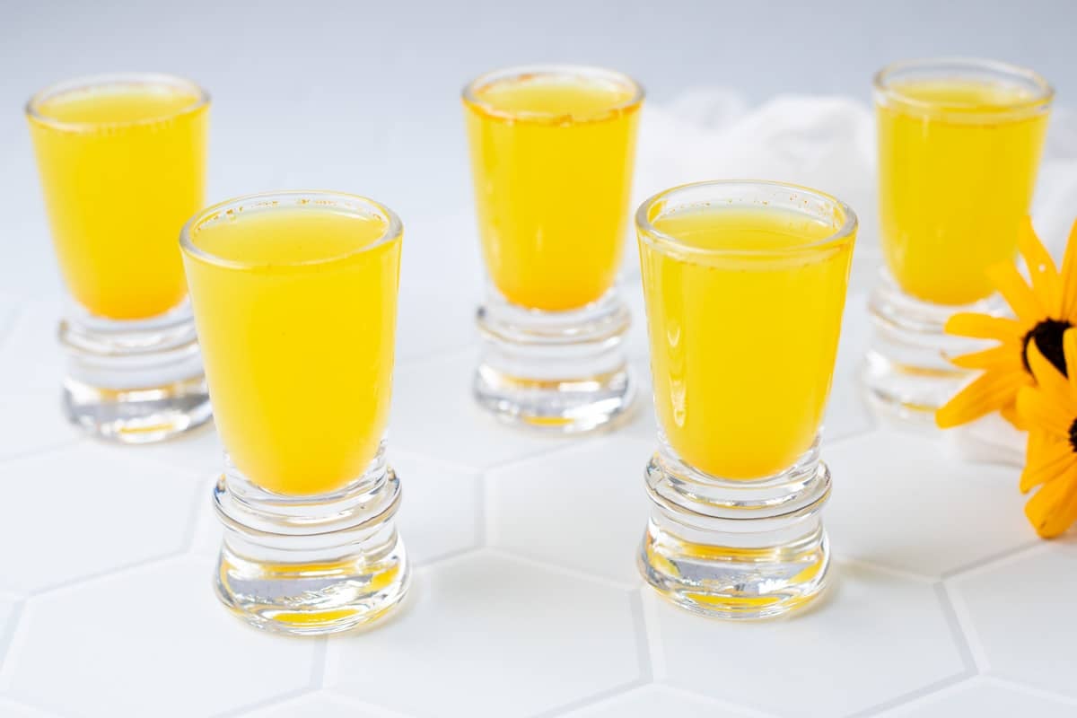 Lemon ginger turmeric juice in shot glasses.
