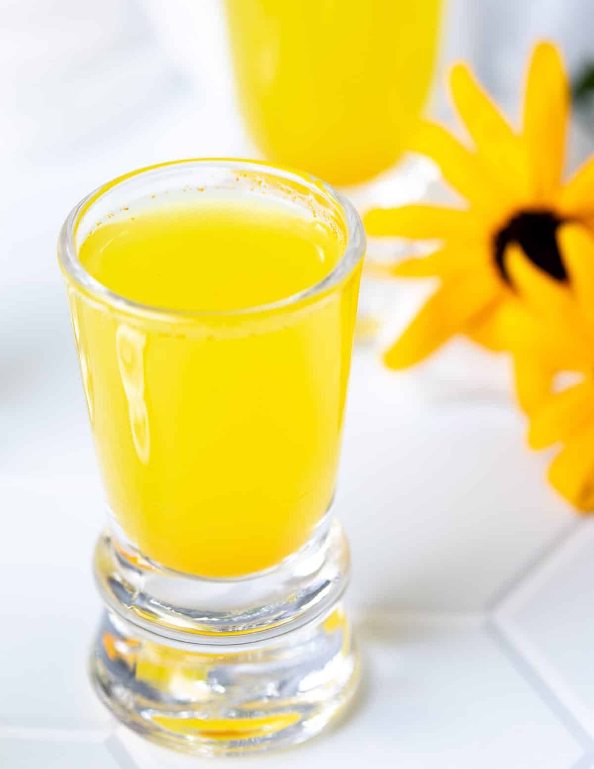 Lemon ginger turmeric shot in shot glass.
