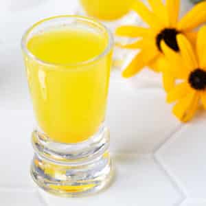Lemon ginger turmeric shot in shot glass.