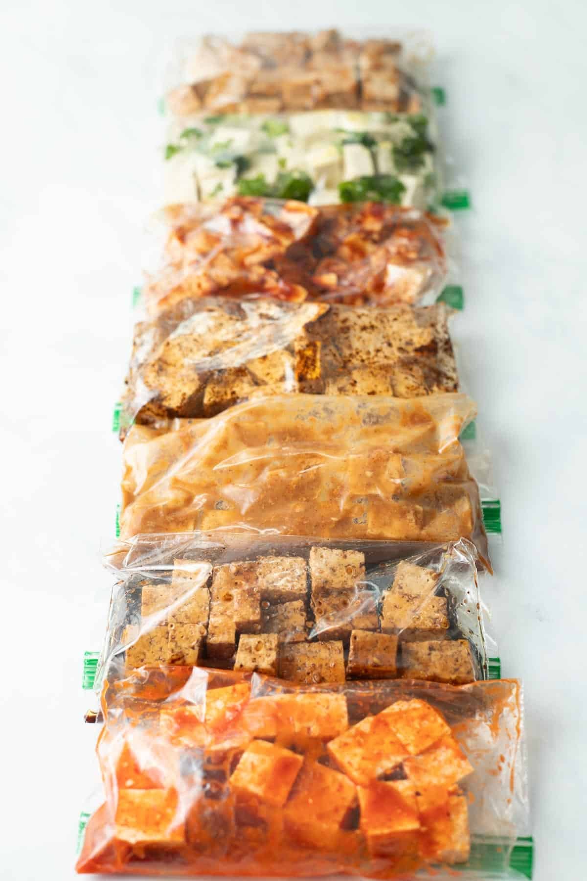 Tofu marinating in baggies in different sauces.
