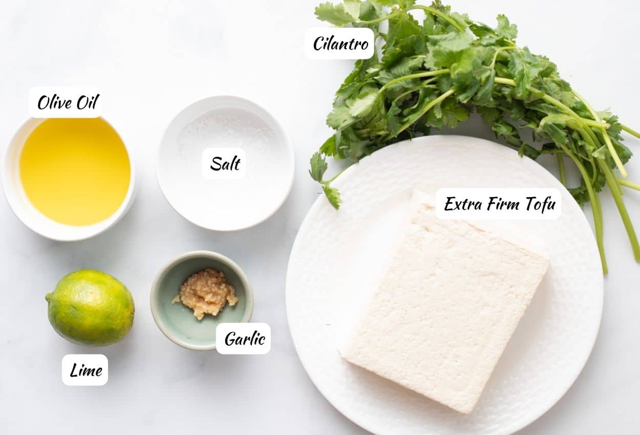 Cilantro lime tofu marinade ingredients: olive oil, lime, garlic, salt, cilantro, tofu.
