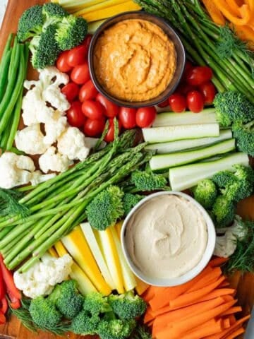 Veggie tray with assorted veggies and dip on a wood serving platter.