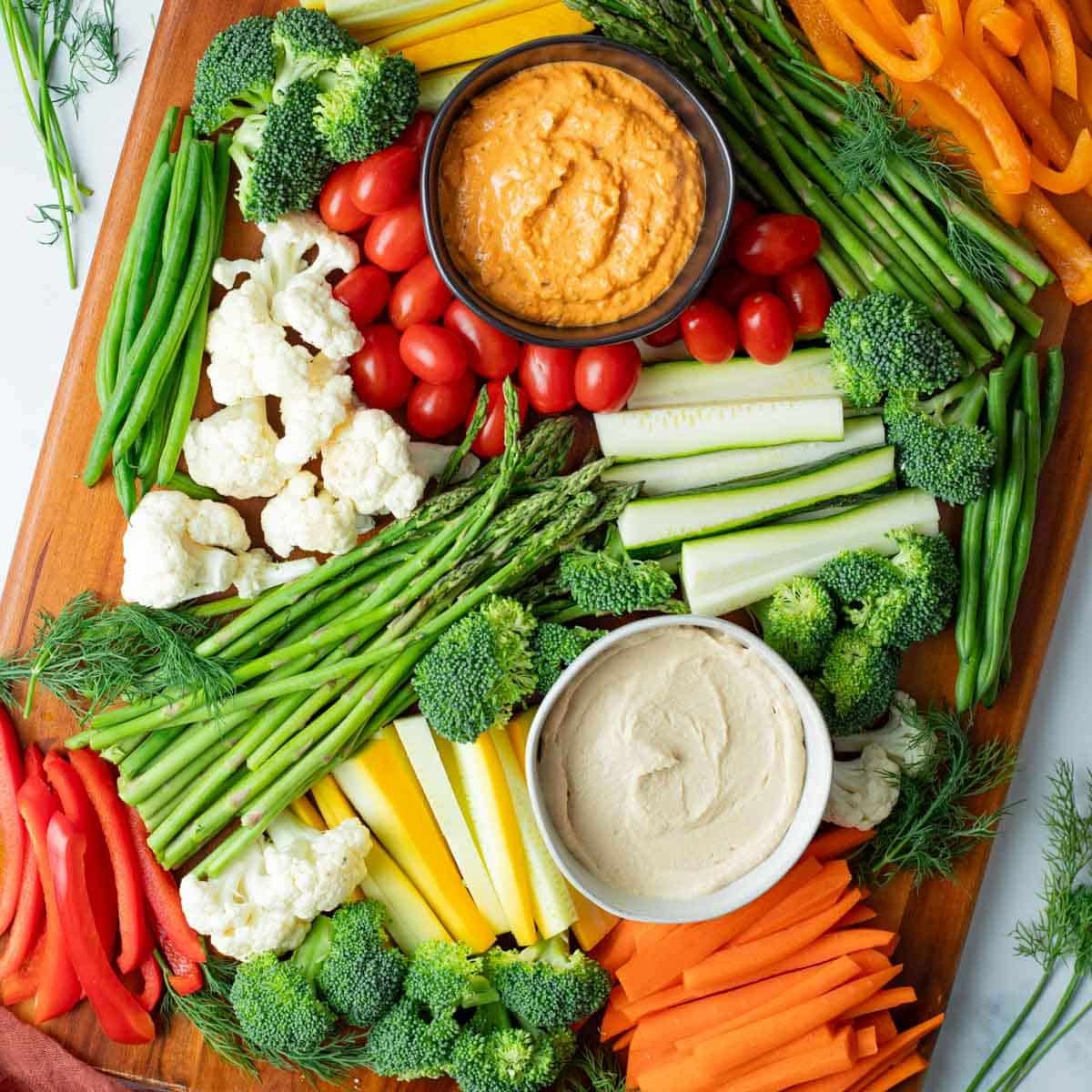 Veggie tray with assorted vegetables and dips.
