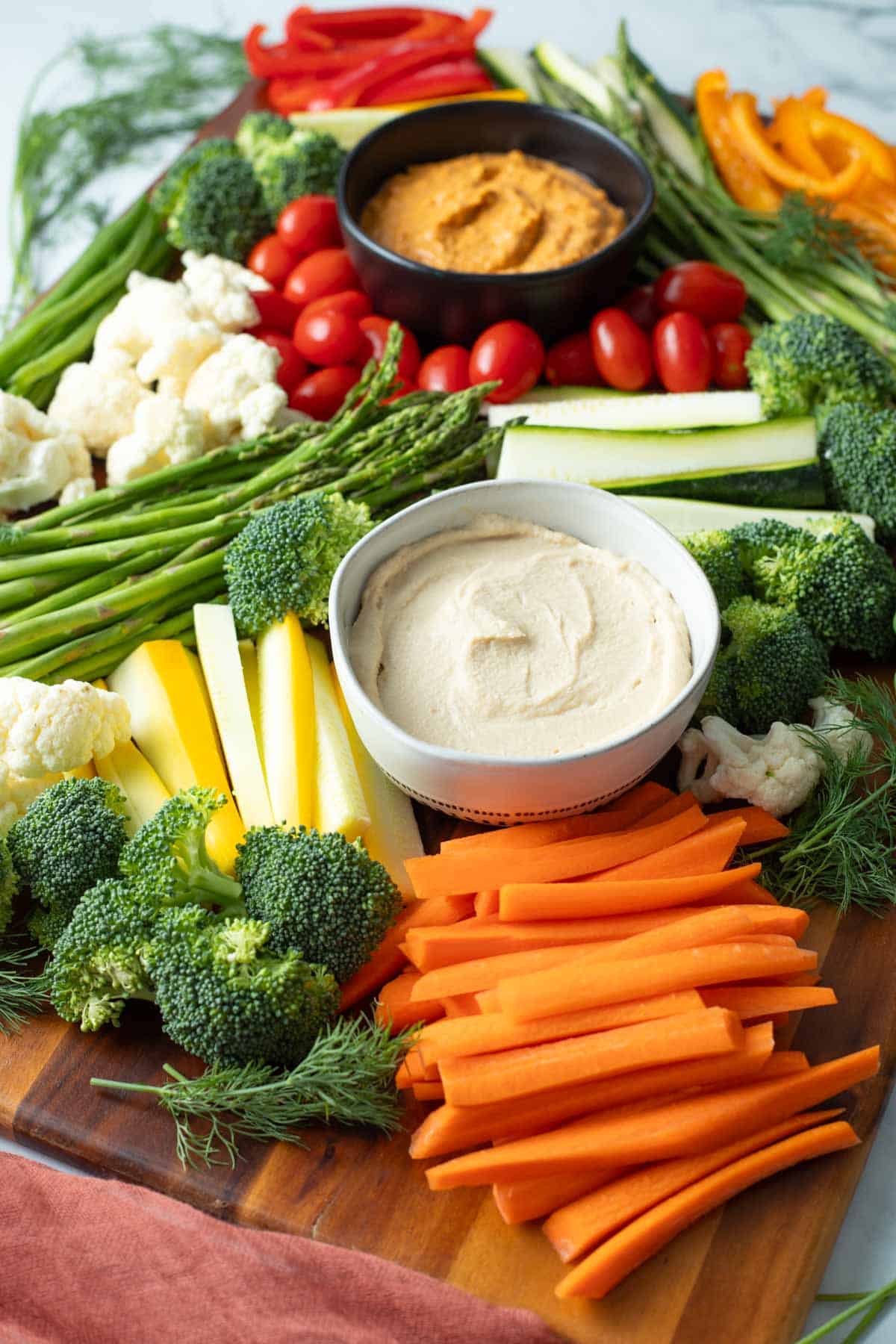 Vegetable tray with hummus and chipotle dip.
