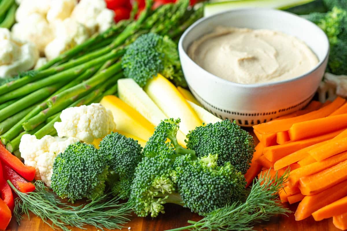 Hummus dip with assorted vegetables .

