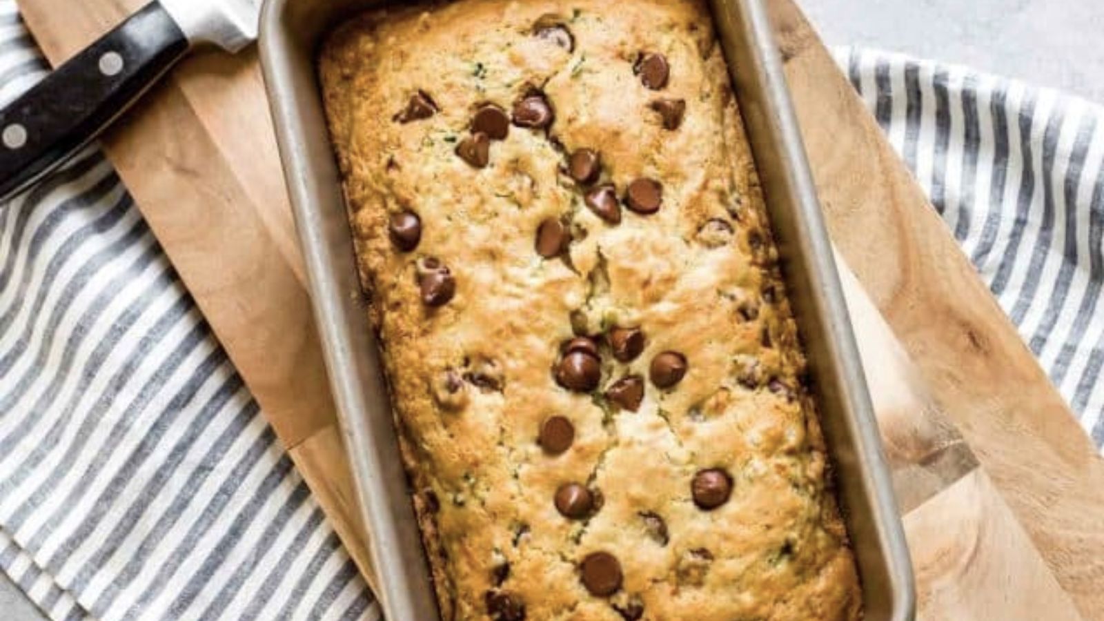 Loaf of zucchini bread topped with chocolate chips.
