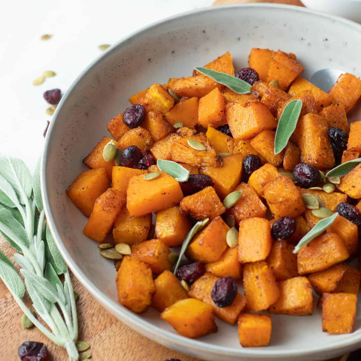 Roasted air fryer butternut squash with cranberries and sage.