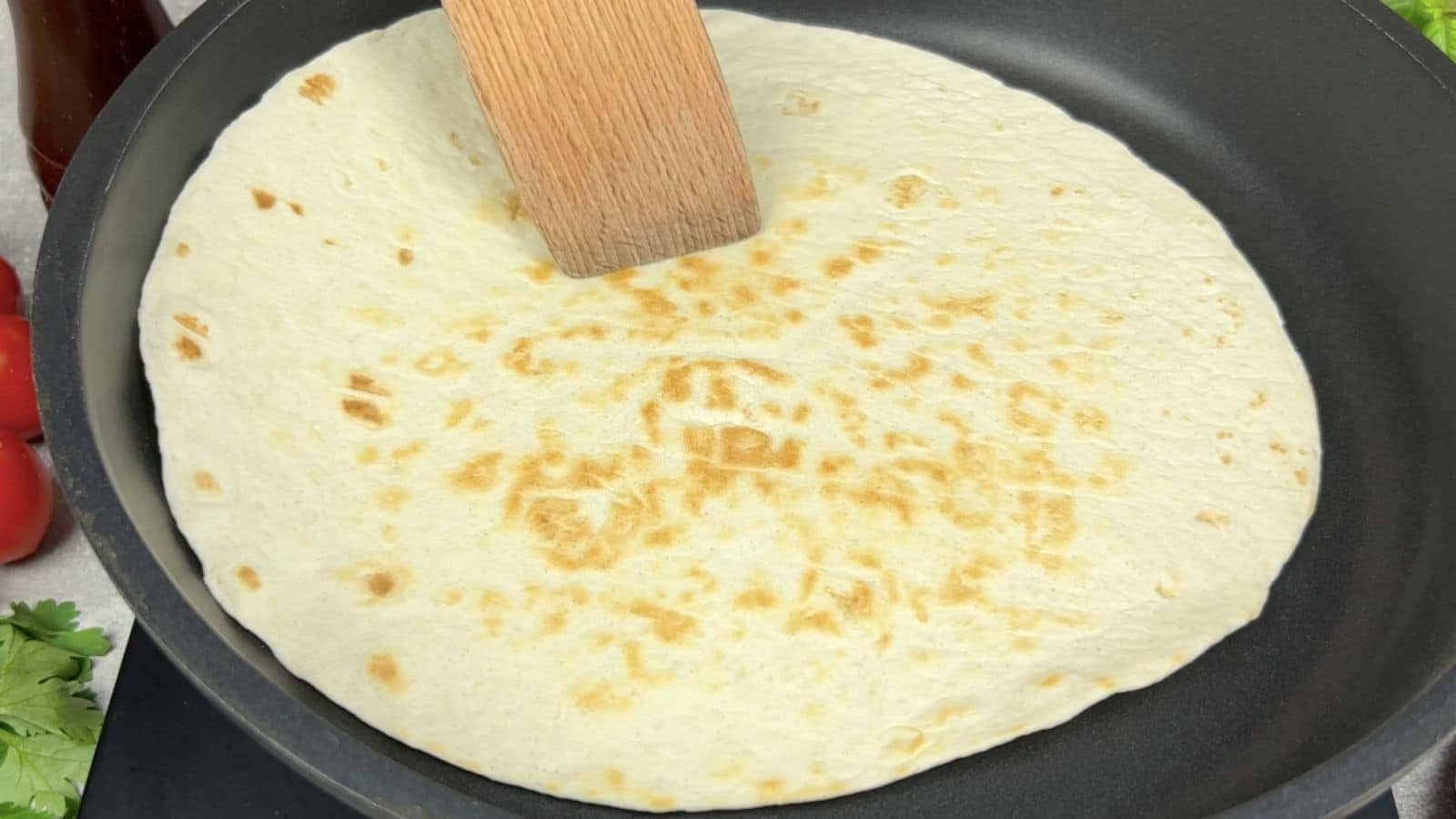 Tortilla warmed on skillet.
