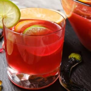 Glass of Hocus Pocus Punch garnished with a lime slice.