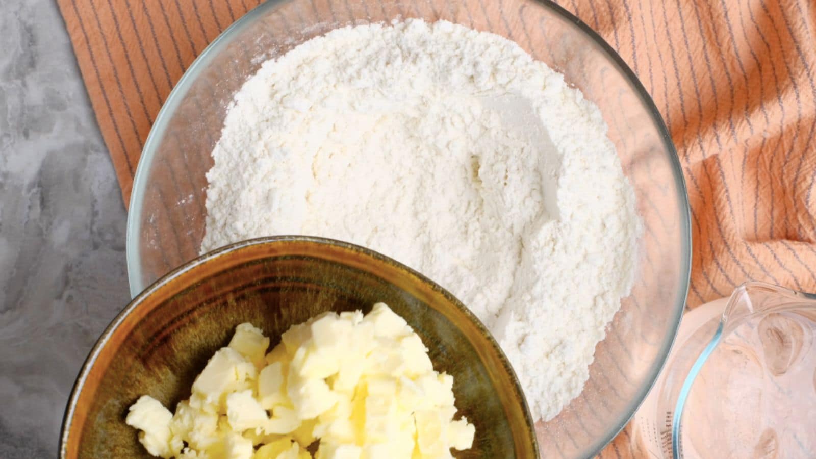 Adding vegan butter to bowl of flour.
