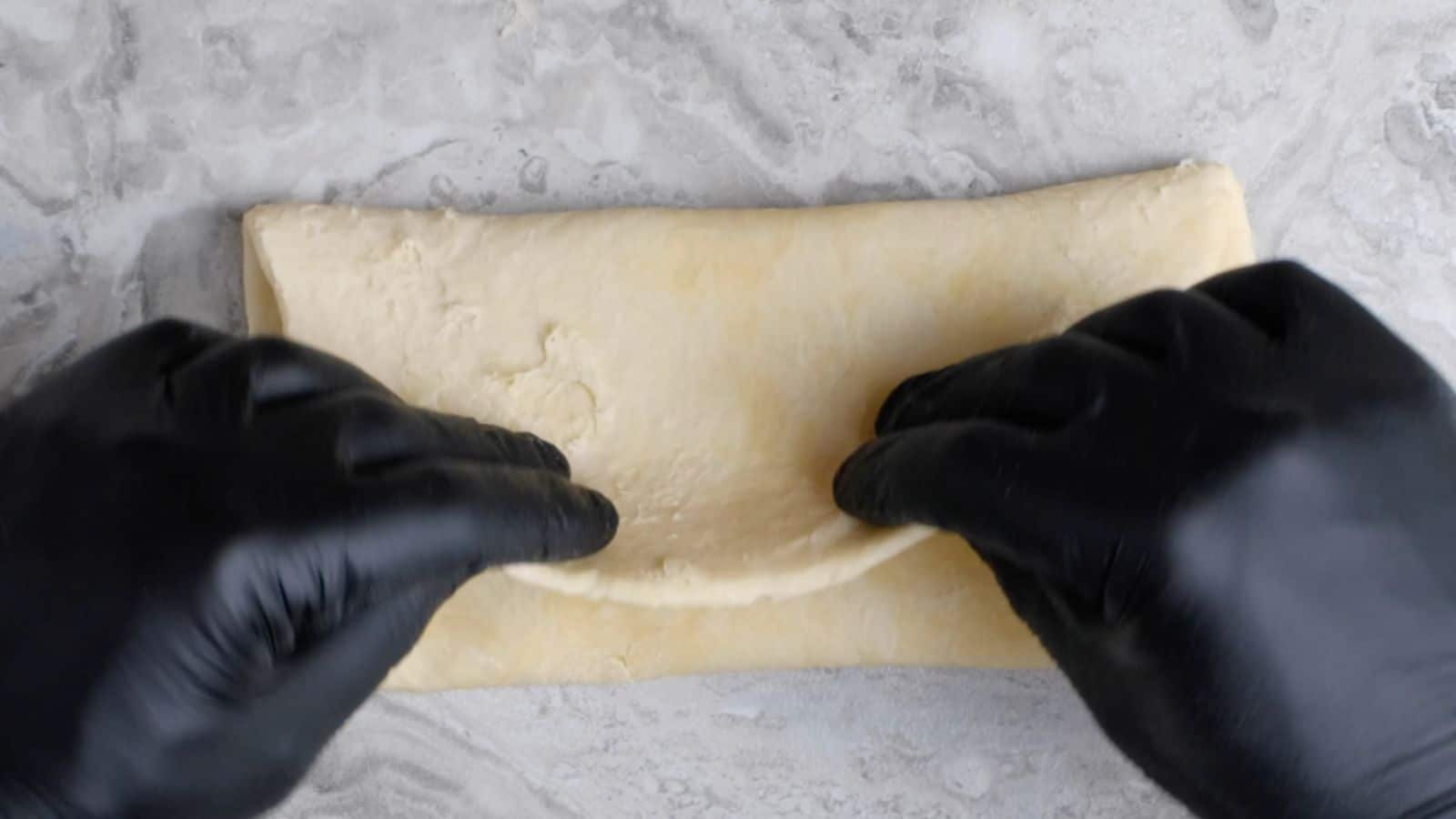 Folding dough in half.
