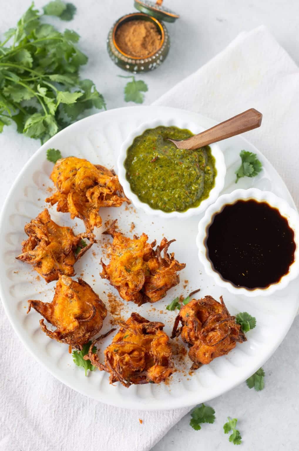 Onion bhaji on a white serving plate. 