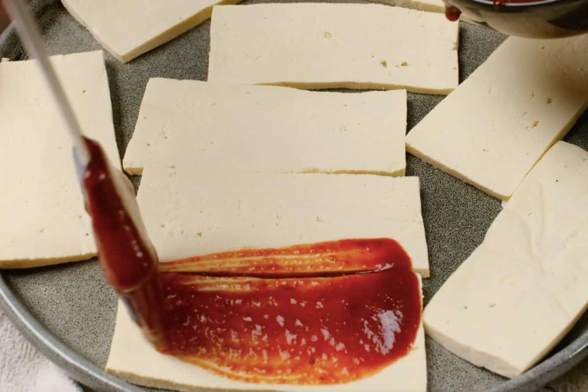 Marinade brushed on tofu slices.
