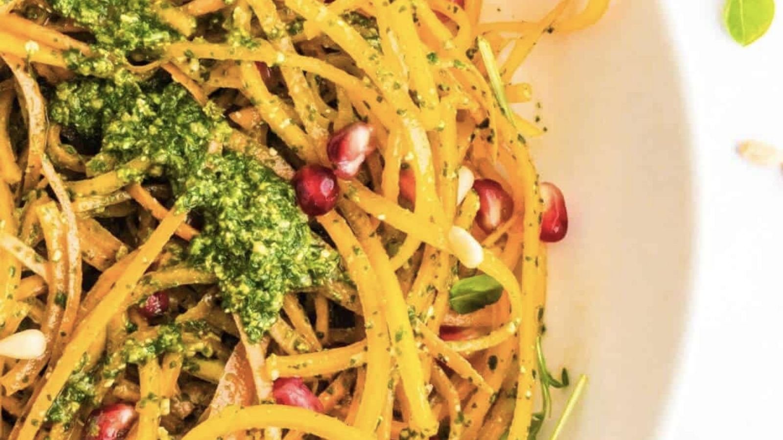 Butternut squash noodles topped with peso and pomegranate seeds. 