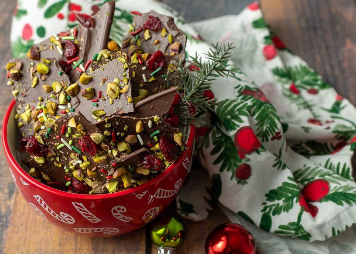 Dark chocolate Christmas bark topped with pistachios, cranberries, and sprinkles.
