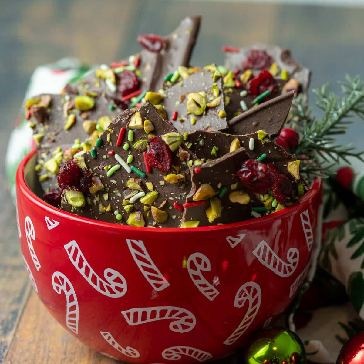 Christmas chocolate bark topped with pistachio, cranberries, and holiday sprinkles.