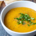 Bowl of vegan potato soup topped with fresh parsley.