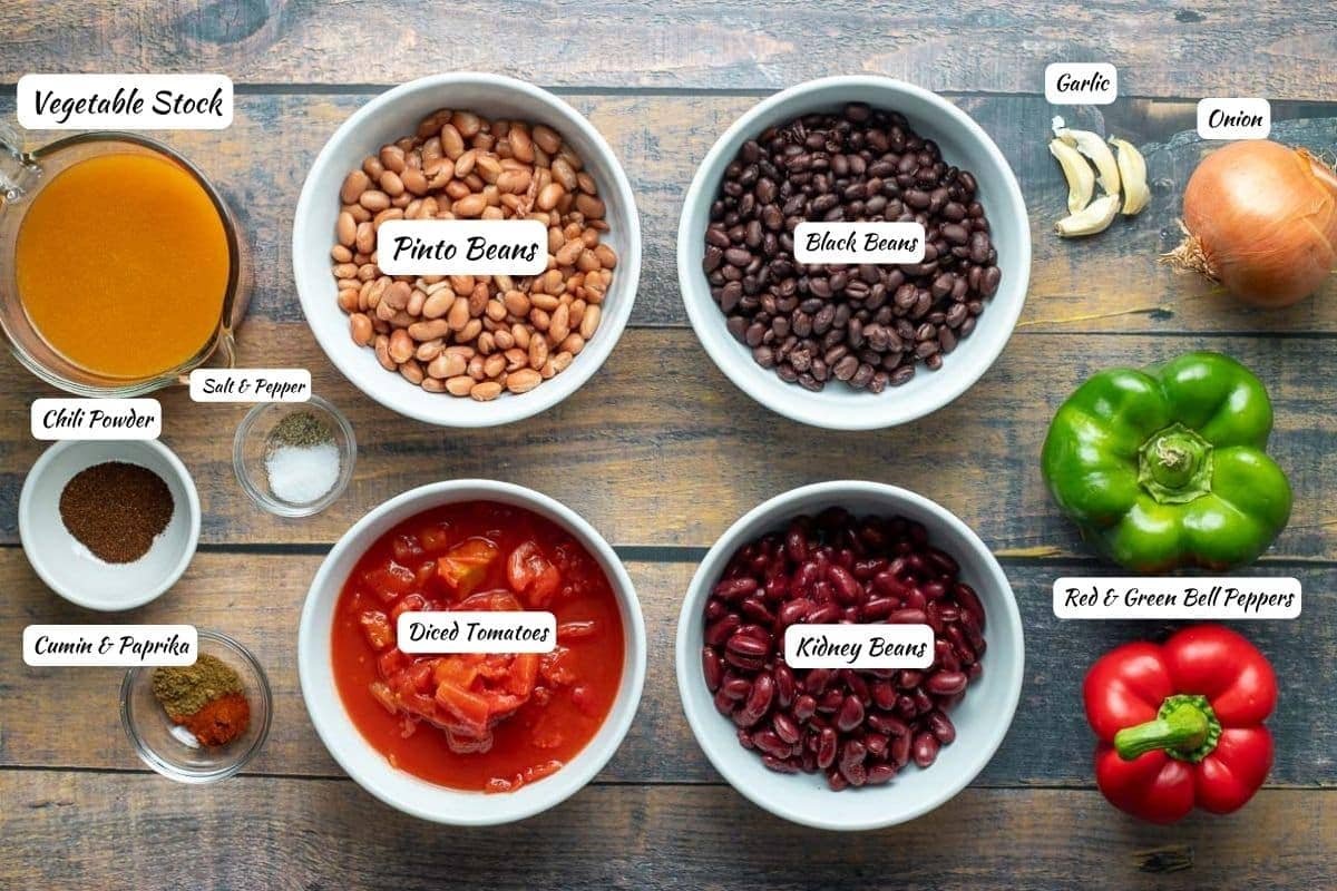 Three bean chili ingredients: vegetable stock, pinto beans, black beans, garlic, onion, green pepper, red pepper, kidney beans, diced tomatoes, cumin & paprika, chili powder, salt & pepper.