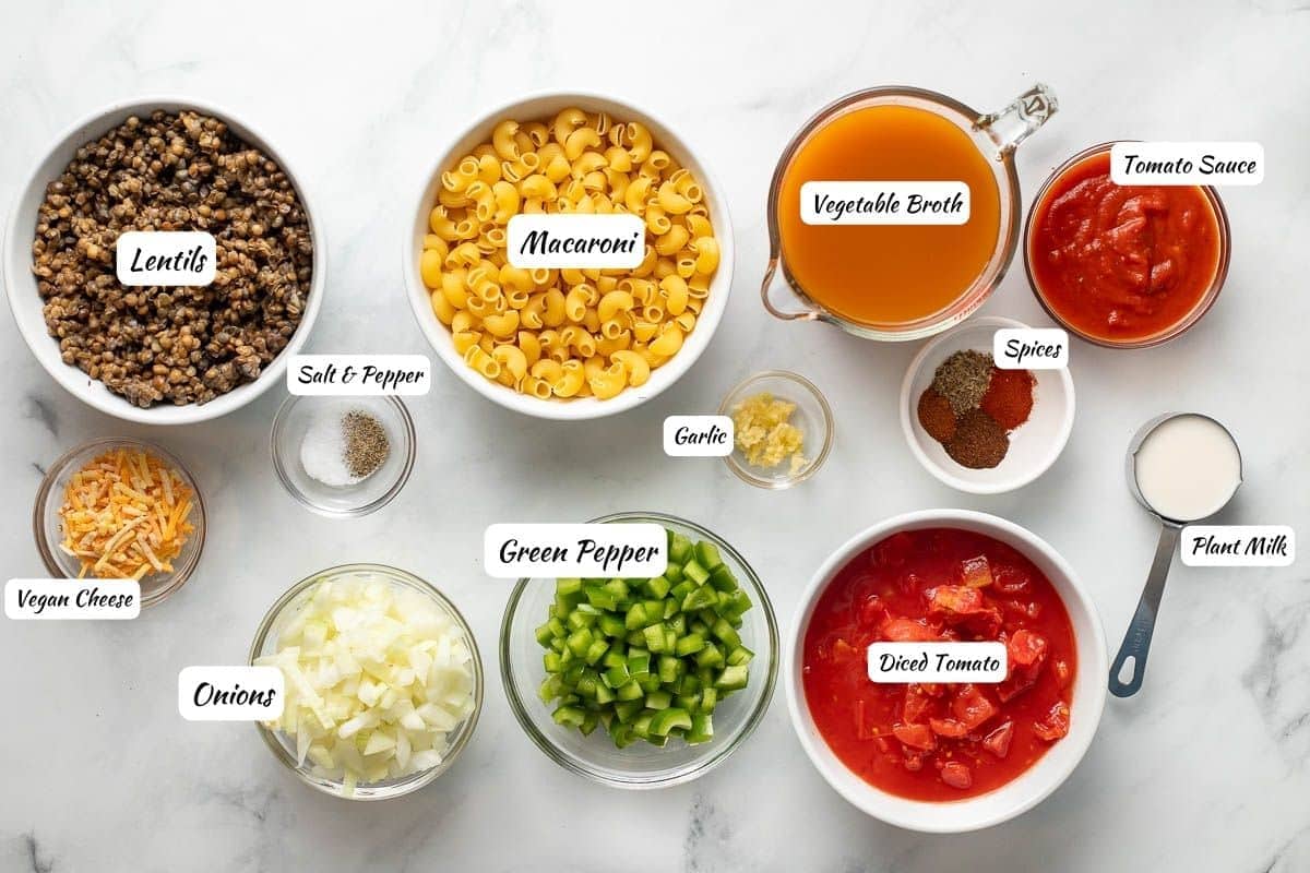 Lentils, macaroni, vegetable broth, tomato sauce, spices, garlic, plant milk, diced tomatoes, green pepper, onion, salt, pepper, vegan cheese.