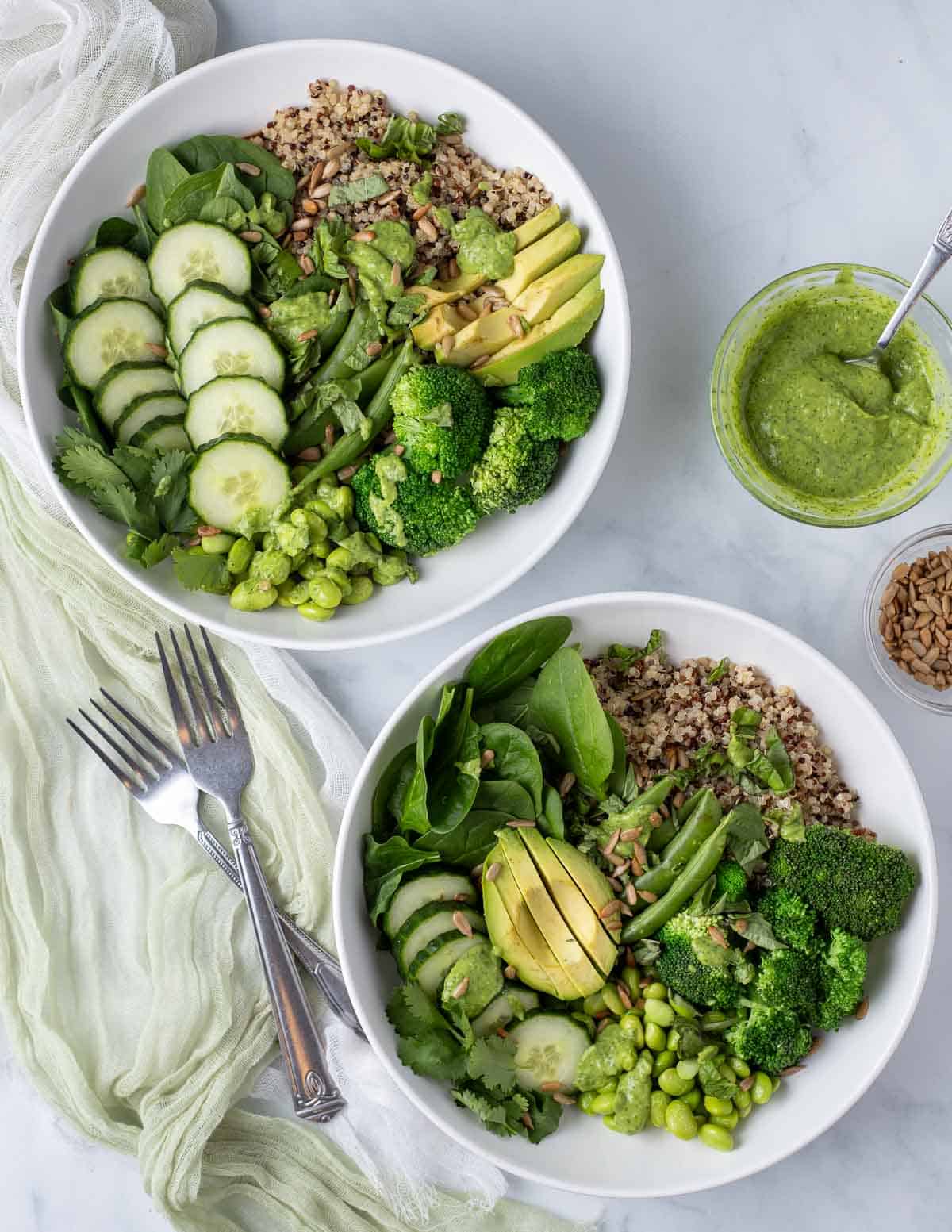 Overhead of two green goddess bowls.