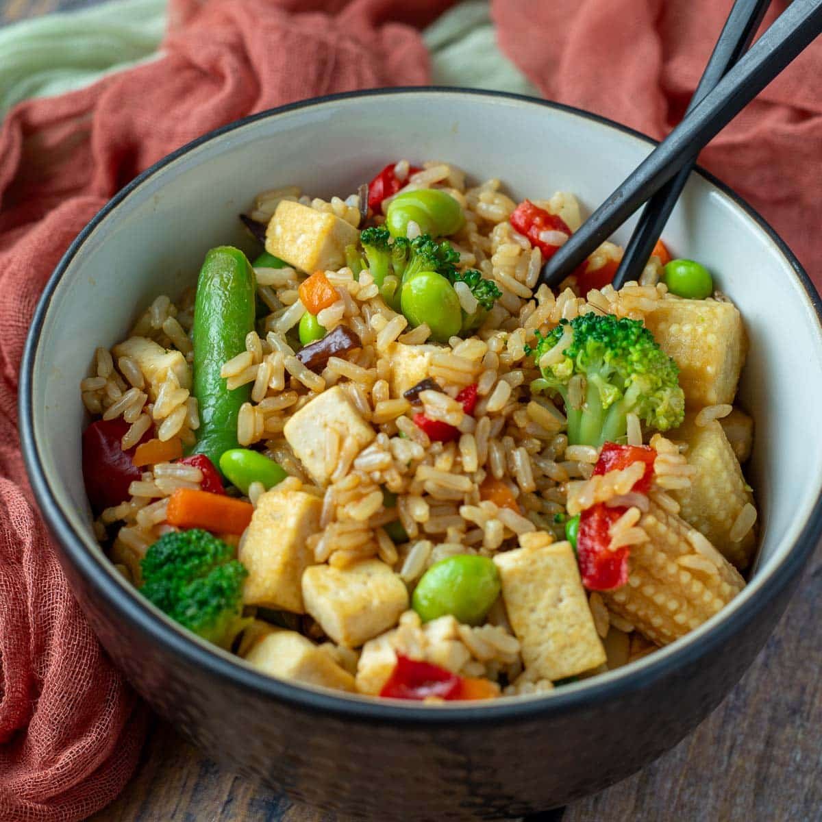 Bowl of fried rice with tofu and mixed vegetables.