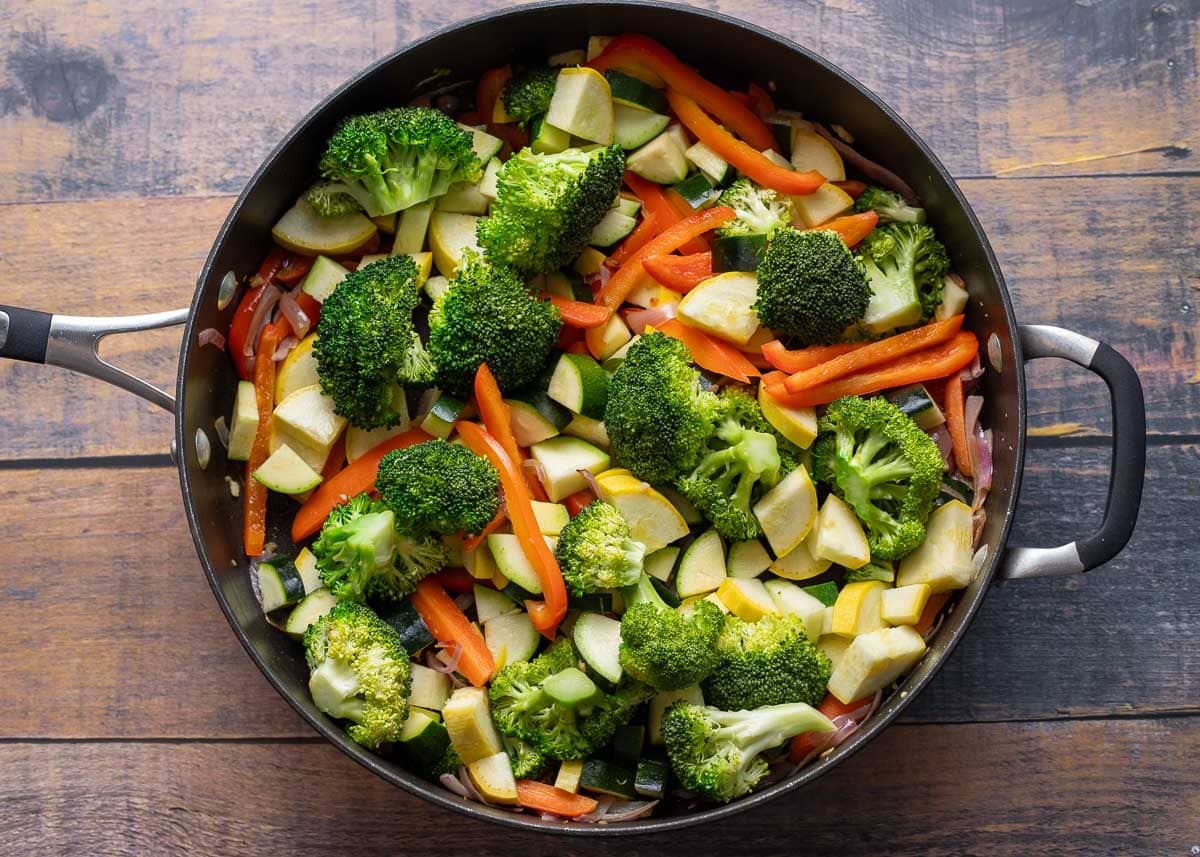 Zucchini and yellow squash added to pan of vegetables.