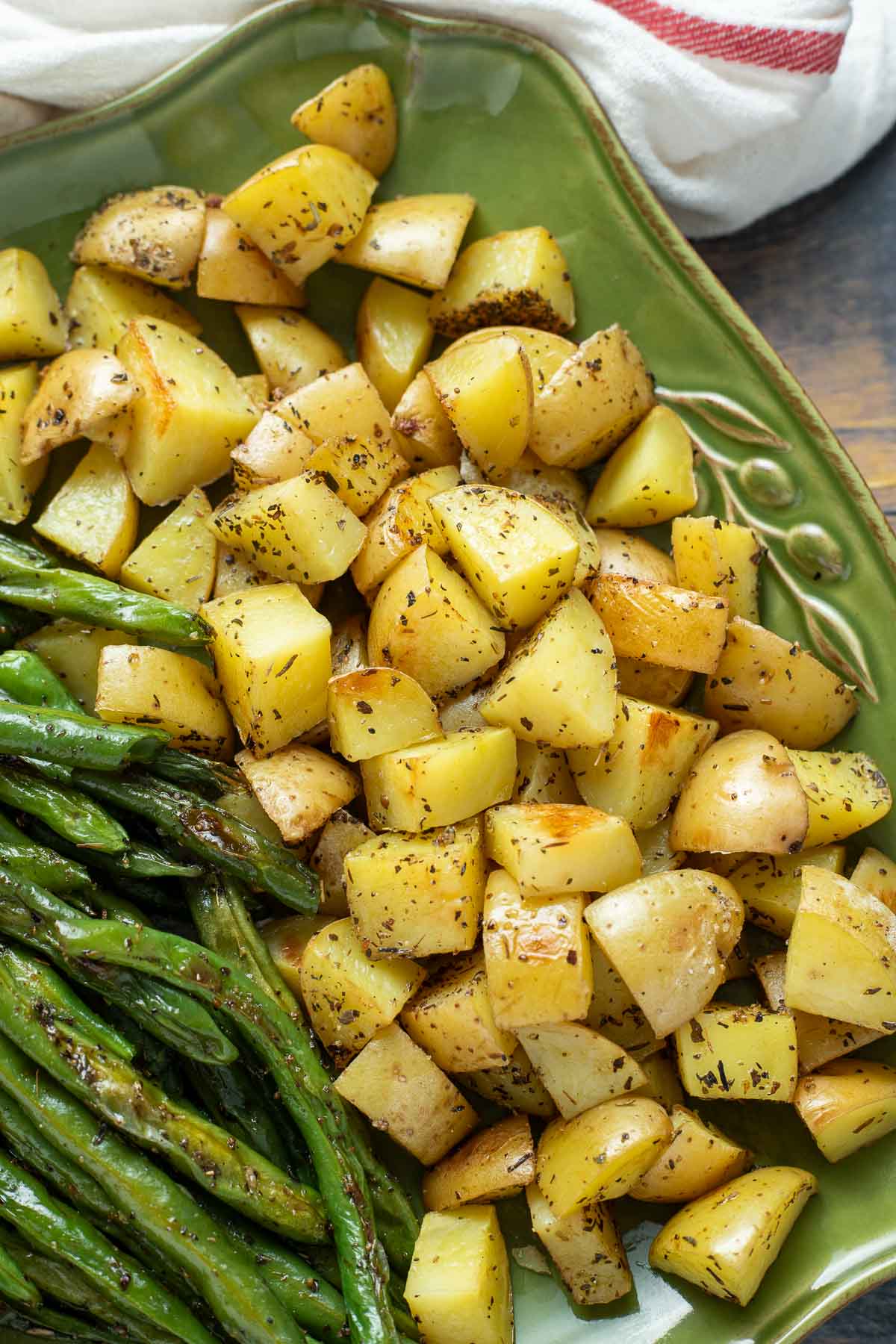 Diced roasted potatoes and green beans on a platter.