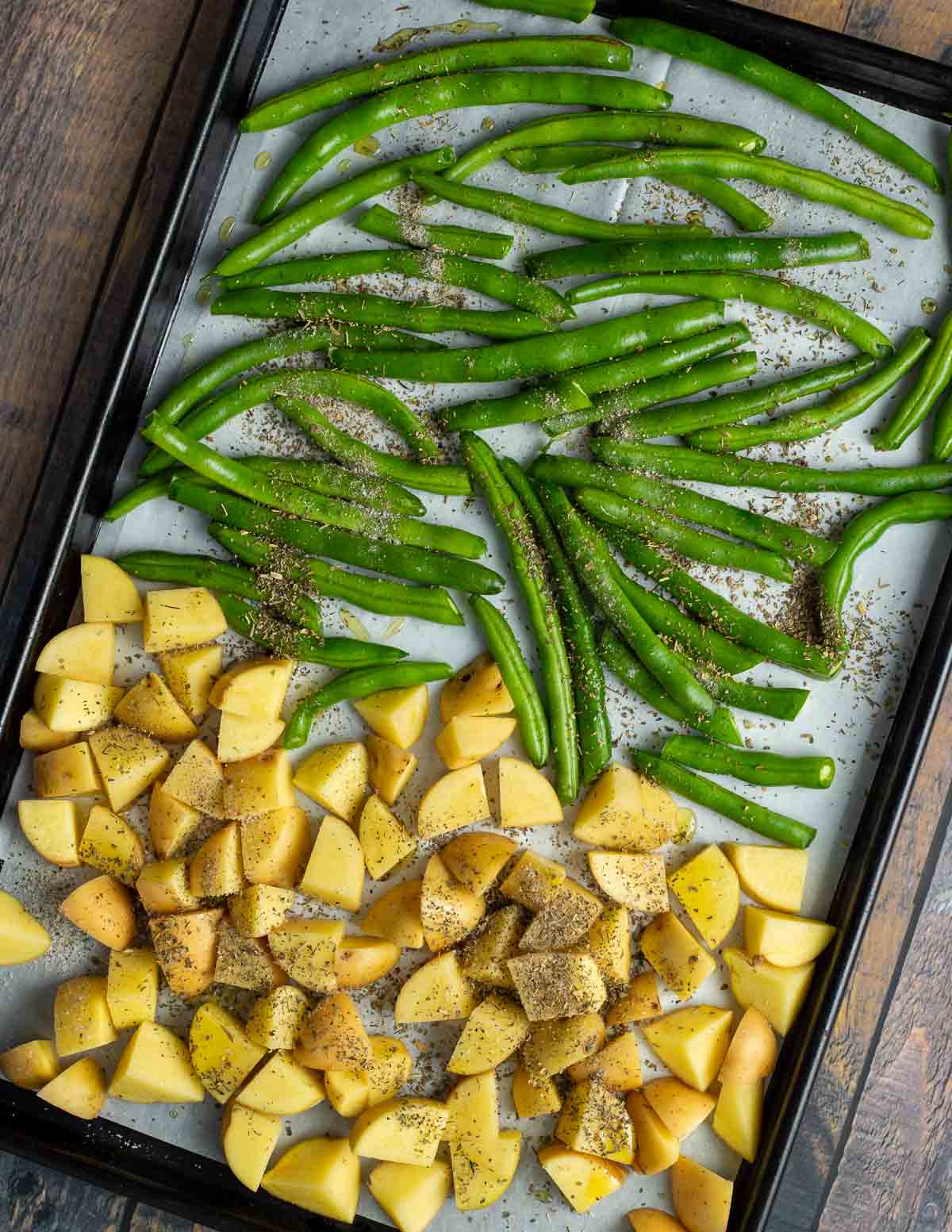 Diced Yukon gold potatoes, and green beans on sheet pan.