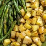 Roasted green beans and potatoes on a platter.